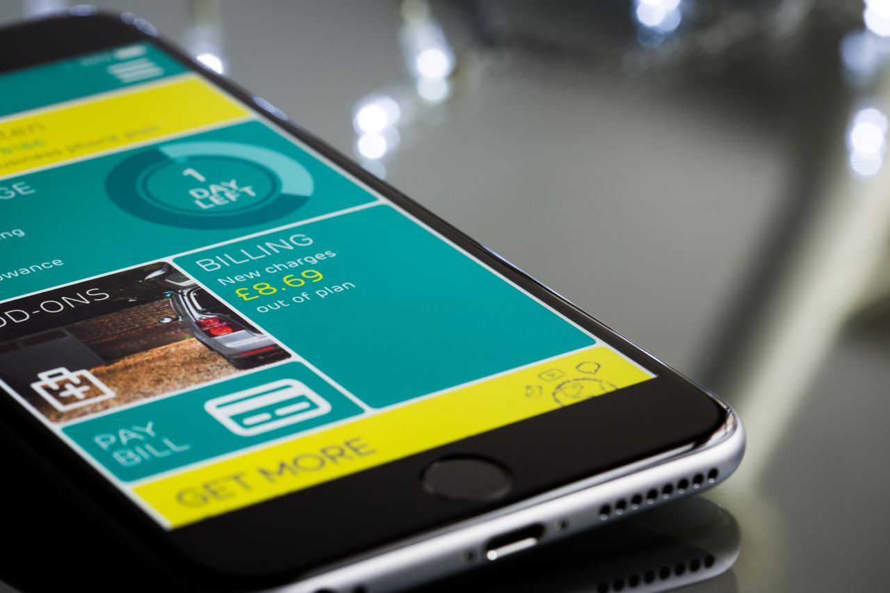 Mastering the First Impression: Your intriguing post title goes here Close-up of a smartphone displaying a billing app interface on a reflective surface.